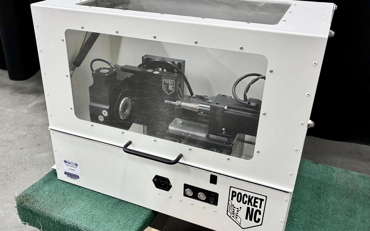Pocket NC CNC machine in an enclosure.