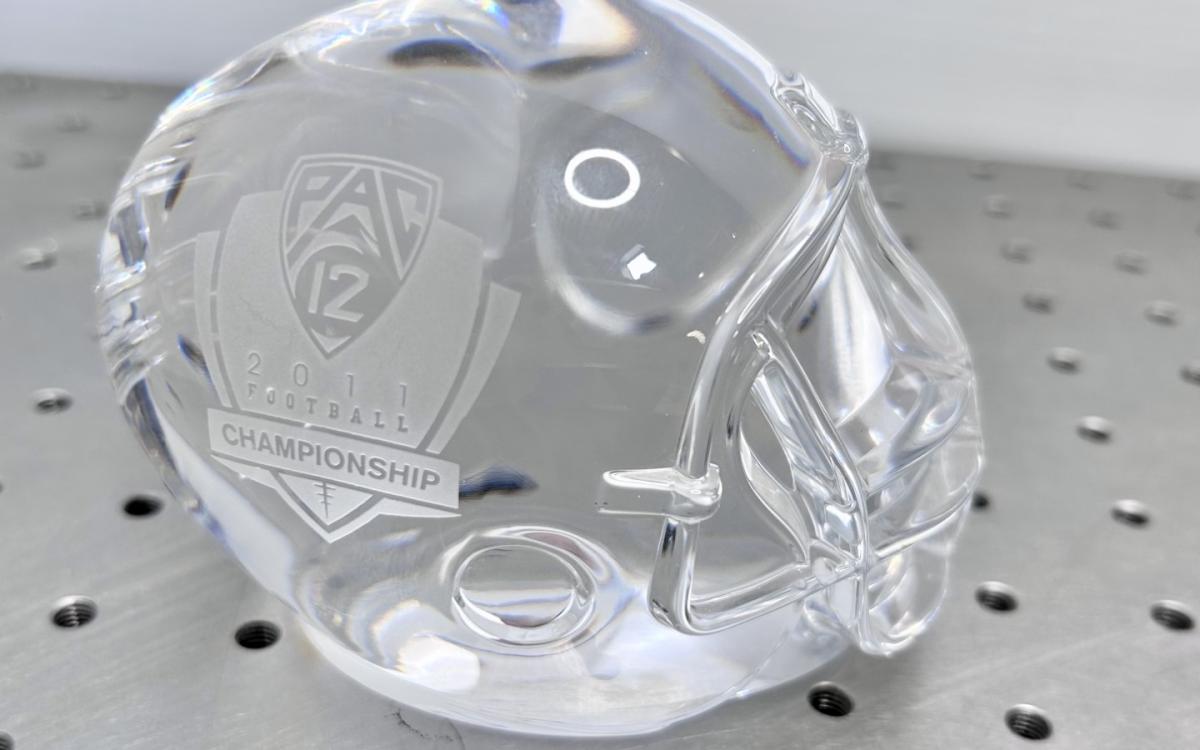 Crystal football helmet etched with "Pac 12 2011 Football Championship" ont he side.