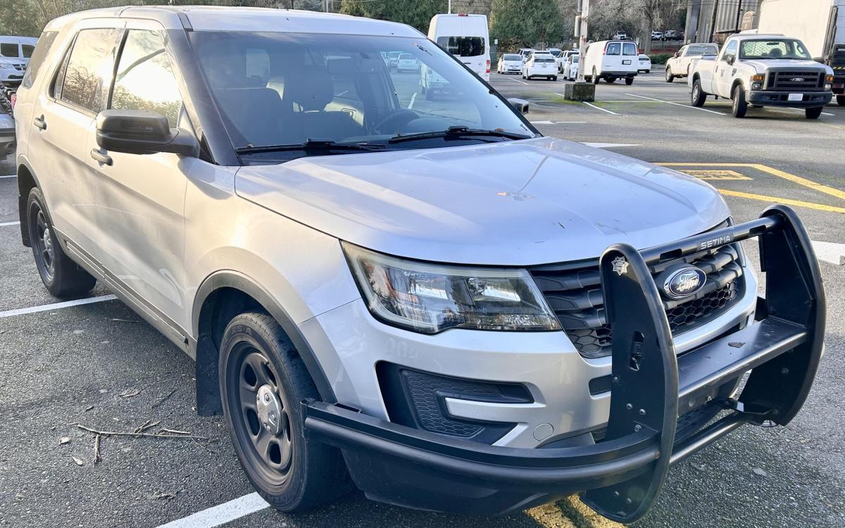 Silver Ford Explorer in a parking lot.