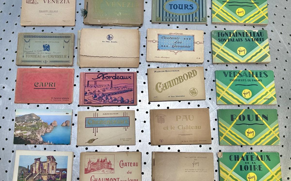 Colorful booklets of vintage postcards from various European destinations.