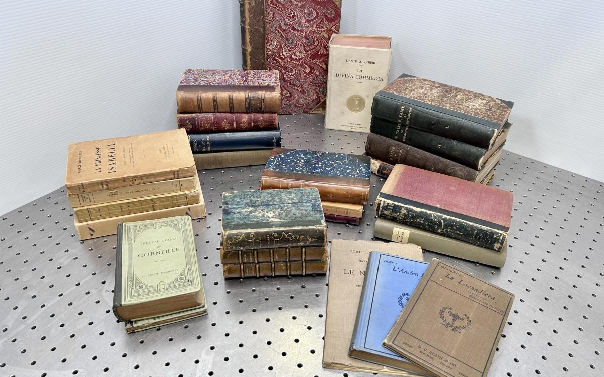 Old books stacked together on a table.
