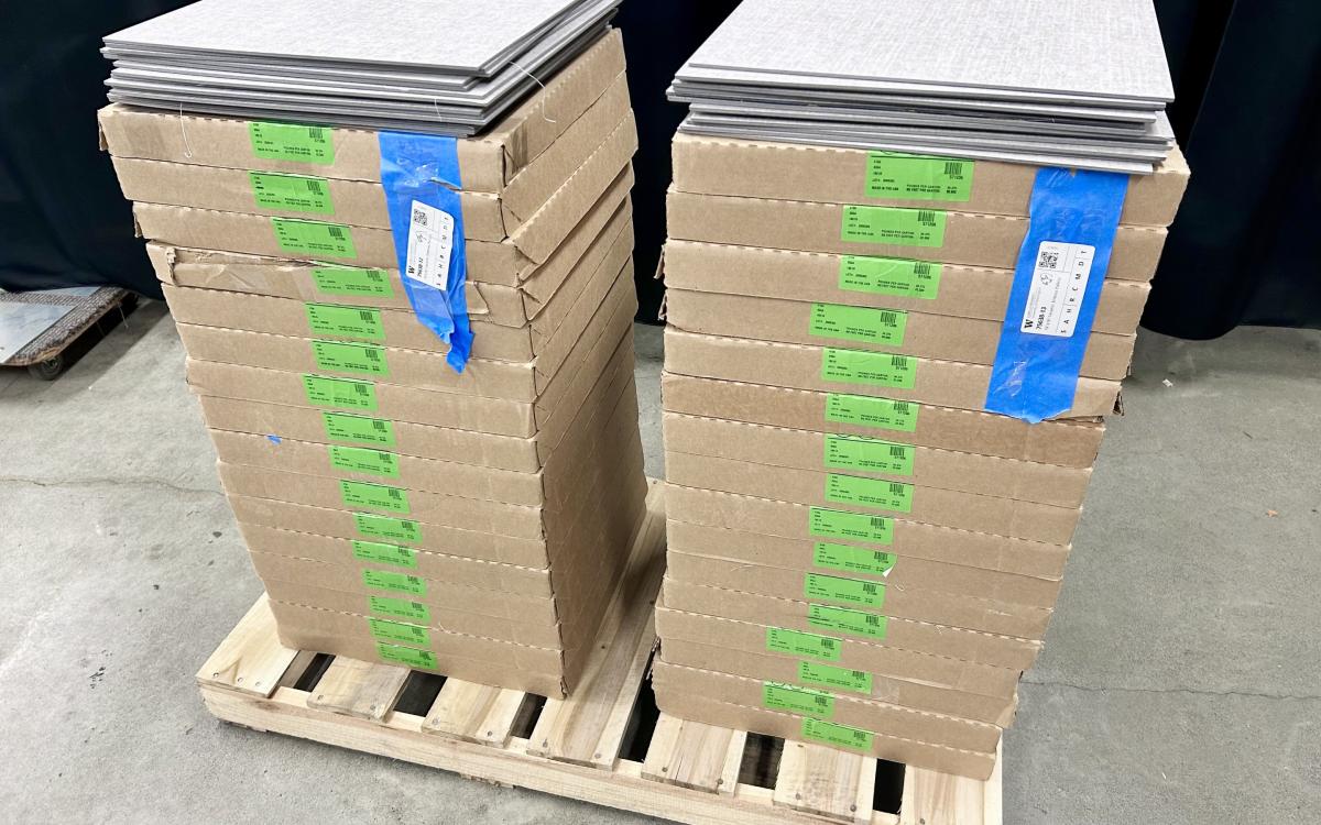 Cartons of LVT flooring stacked on a small pallet.