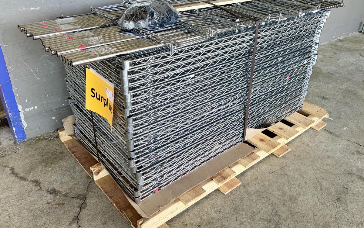 Pallet full of disassembled industrial wire racks.