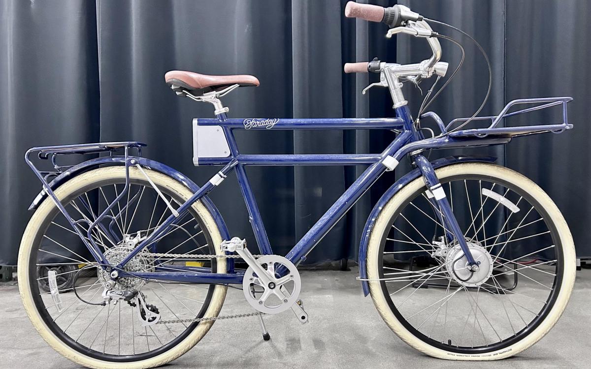 Blue Faraday electric bike with white tires.