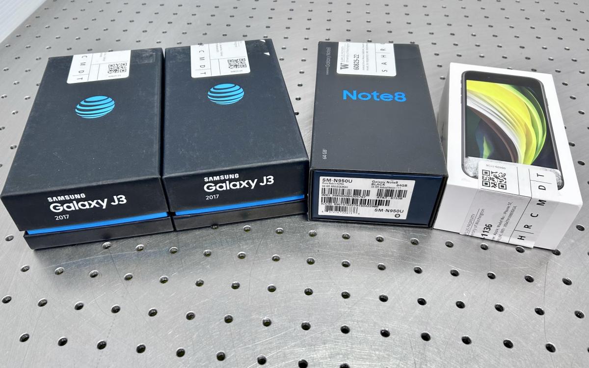 Four smartphone boxes on a tabletop.