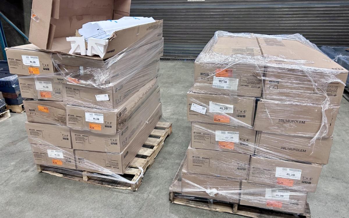 Two pallets full fo large boxes of troffer lights.