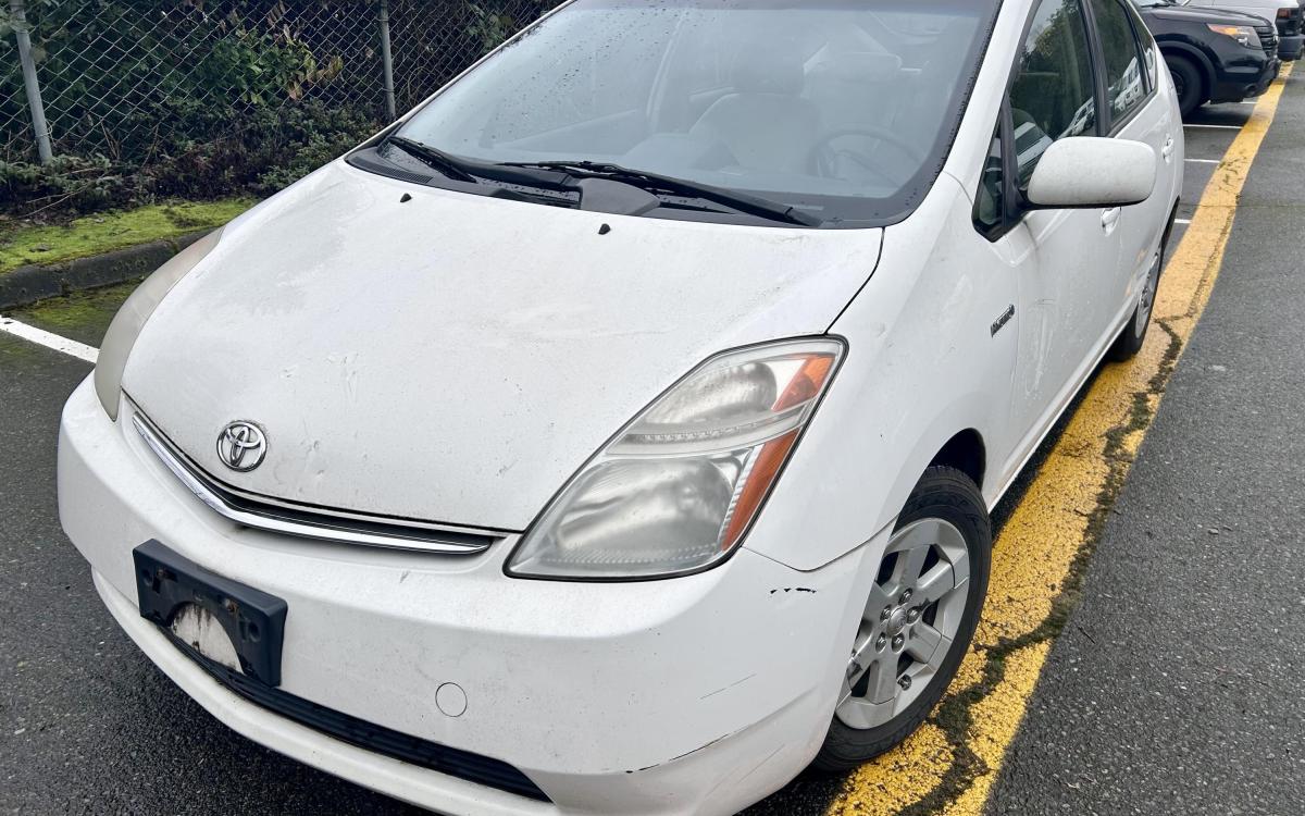 White 2009 Toyota Prius in a parking lot.