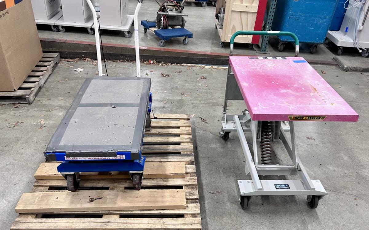 Two pieces of moving equipment in a warehouse.