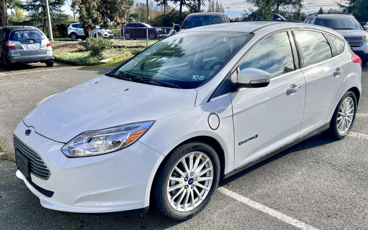 White electric Ford Focus in a parking lot.