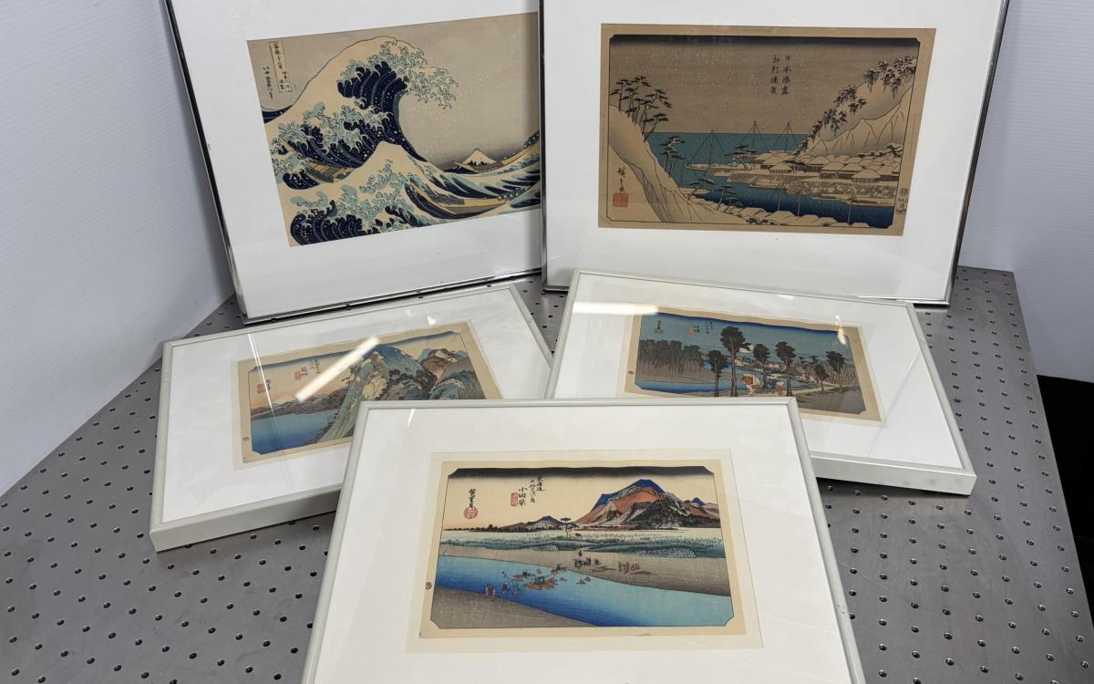 Five pieces of framed art on display.