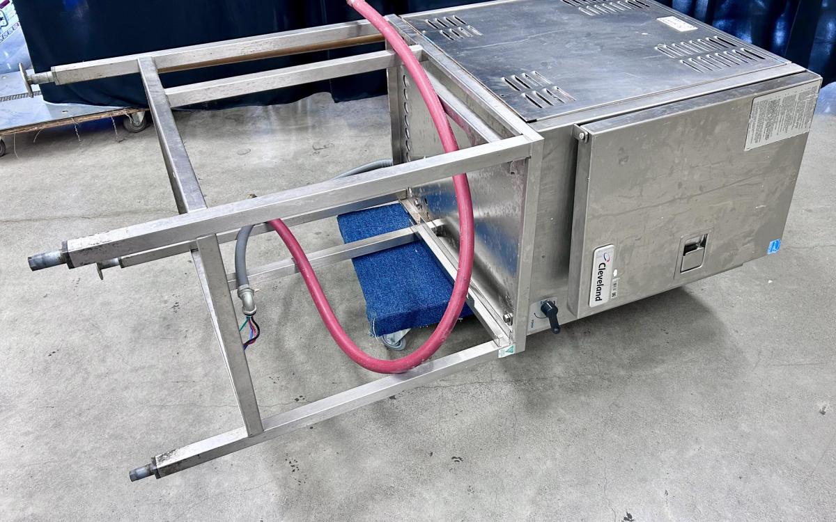 Cleveland commercial kitchen steamer on its side in a warehouse.