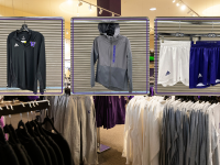 black quarter zip jacket, grey raincoat, and shorts in white and purple