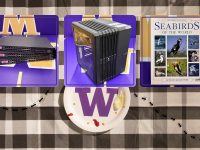 a stack of computer switches, a computer CubeCase, a book of seabirds  on a picnic table setting