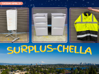 a rolling whiteboard, two small file cabinets, a high visibility jacket on a picture of the seattle skyline