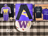 a husky branded baseball shirt, a pair of black sweatpants, a set of matching "prospect camp" branded shirts on a picnic table setting