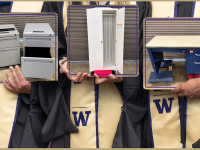 three people in graduation robes holding up images of two pedestal filing cabinets, a white cabinet and a blue tanker desk