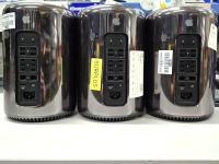Three black round apple Mac Pro computers.