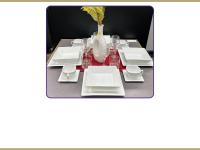 a table with cups, plates, mugs, a vase and placemats