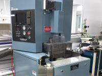 Large industrial wafer grinder equipment in a lab.