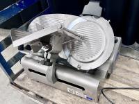 Metal commercial deli slicer on a cart.
