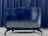 Sharp interactive TV on a rolling stand. 