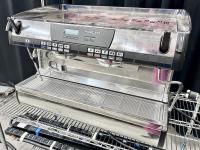 Shiny espresso machine on a cart.