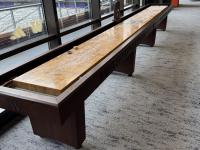 Shuffle board with Husky Stadium seating visible in the background.
