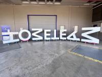 Large letters that spell HOME TEAM on a loading dock. Not all letters are oriented correctly.
