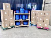 Boxes of Cat-6A cable, with a cart full of spools of the same cable between the stacks of boxes.