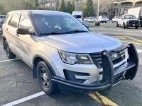 Silver Ford Explorer in a parking lot.