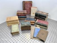 Old books stacked together on a table.