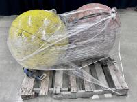 Two round metal buoys on a pallet.