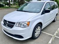 White 2014 Dodge Caravan minivan.