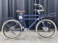 Blue Faraday electric bike with white tires.