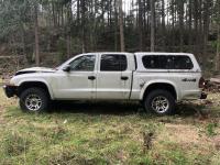 White Dodge Dakota pickup truck with damage to the front end.