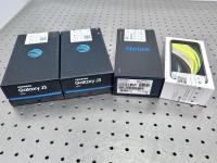 Four smartphone boxes on a tabletop.