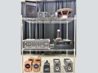 Cart with miscellaneous audio equipment on the shelves.
