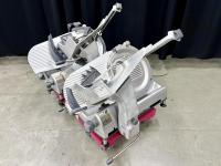 Two similar commercial deli food slicers on a dolly.