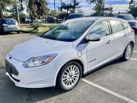 White electric Ford Focus in a parking lot.