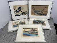 Five pieces of framed art on display.