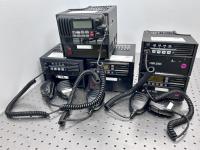 Five black mobile radios with attached microphones.