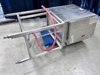 Cleveland commercial kitchen steamer on its side in a warehouse.