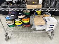 Rolls of 3D printer fillament on a cart.