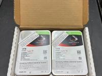 Two Seagate hard drives in a box.